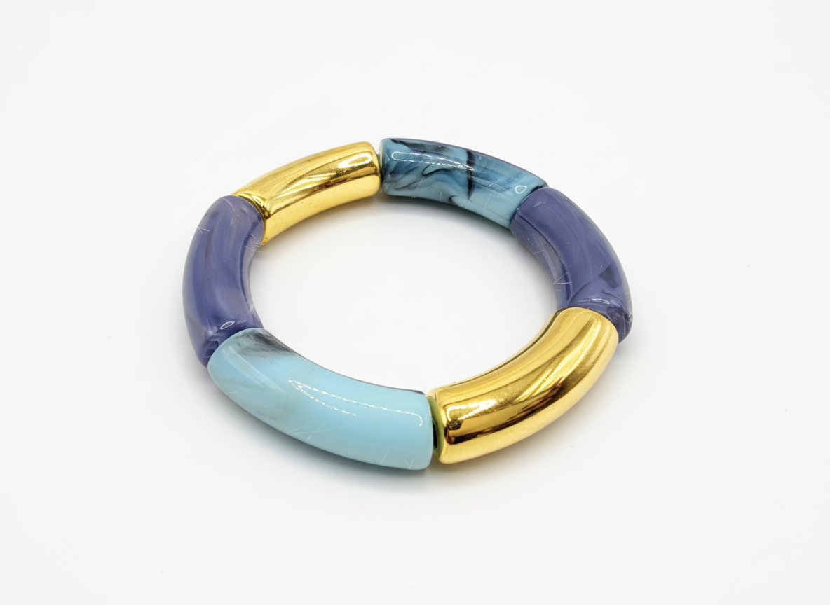 Multicolored bracelet with gold and blue accents on a white background