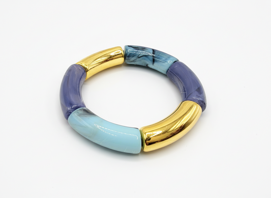 Multicolored bracelet with gold and blue accents on a white background