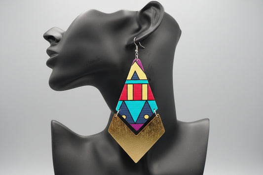 Colorful geometric earring on a mannequin ear against a reflective surface