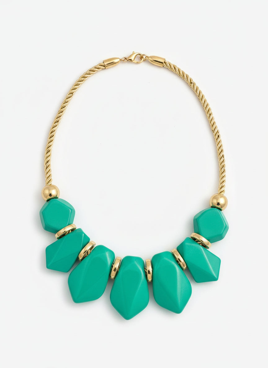  rope necklace with green beads and gold accents on a white background