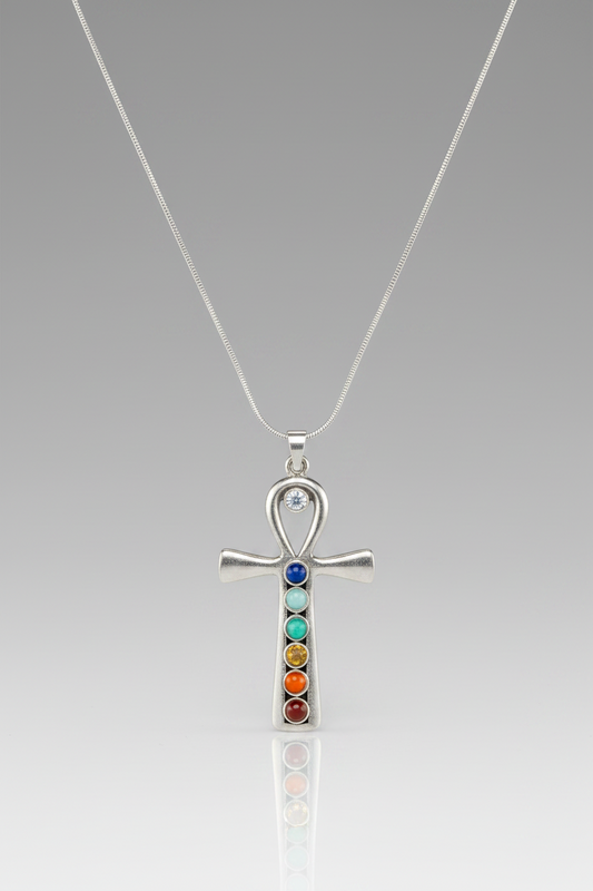 Silver ankh pendant with colorful stones on a gray background